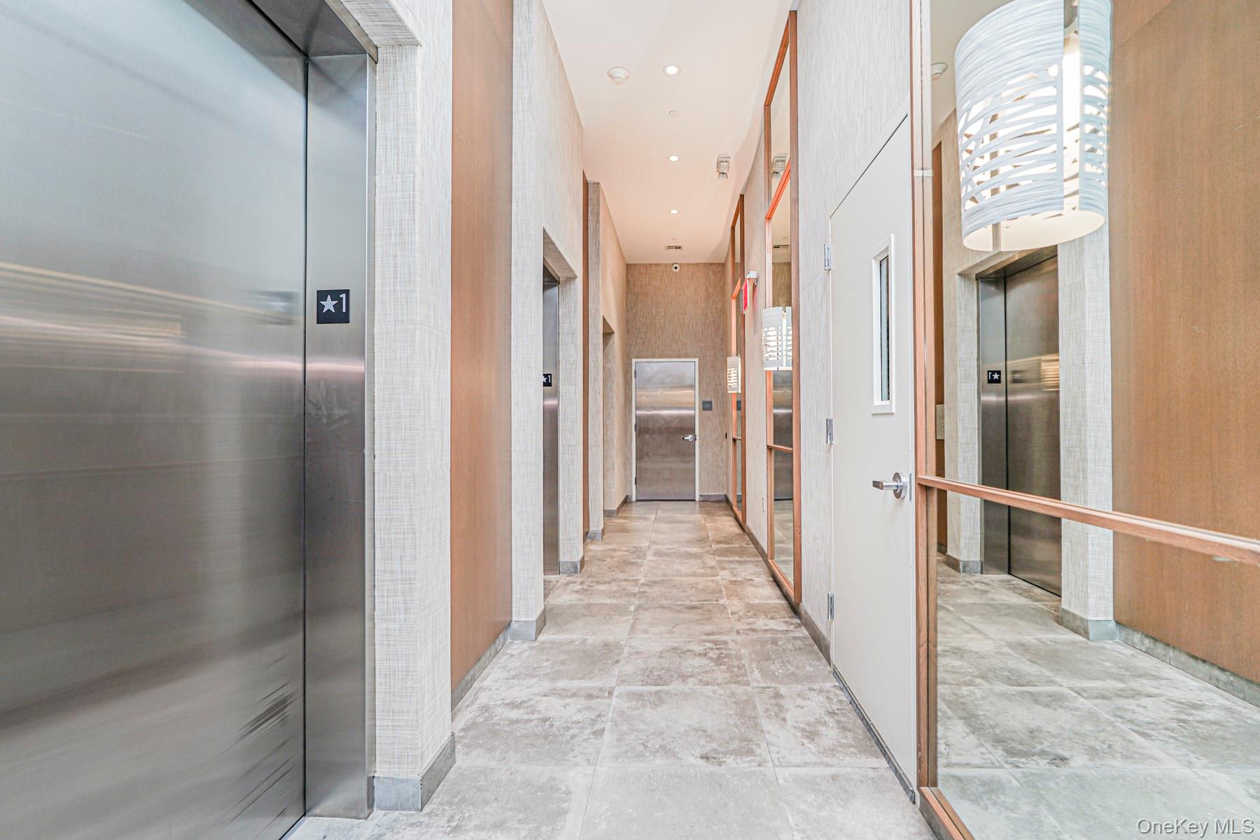 133 Beach 116th Street, Unit 2C Queens, NY 11694 - Photo 5 of 35 a view of a hallway with a chandelier