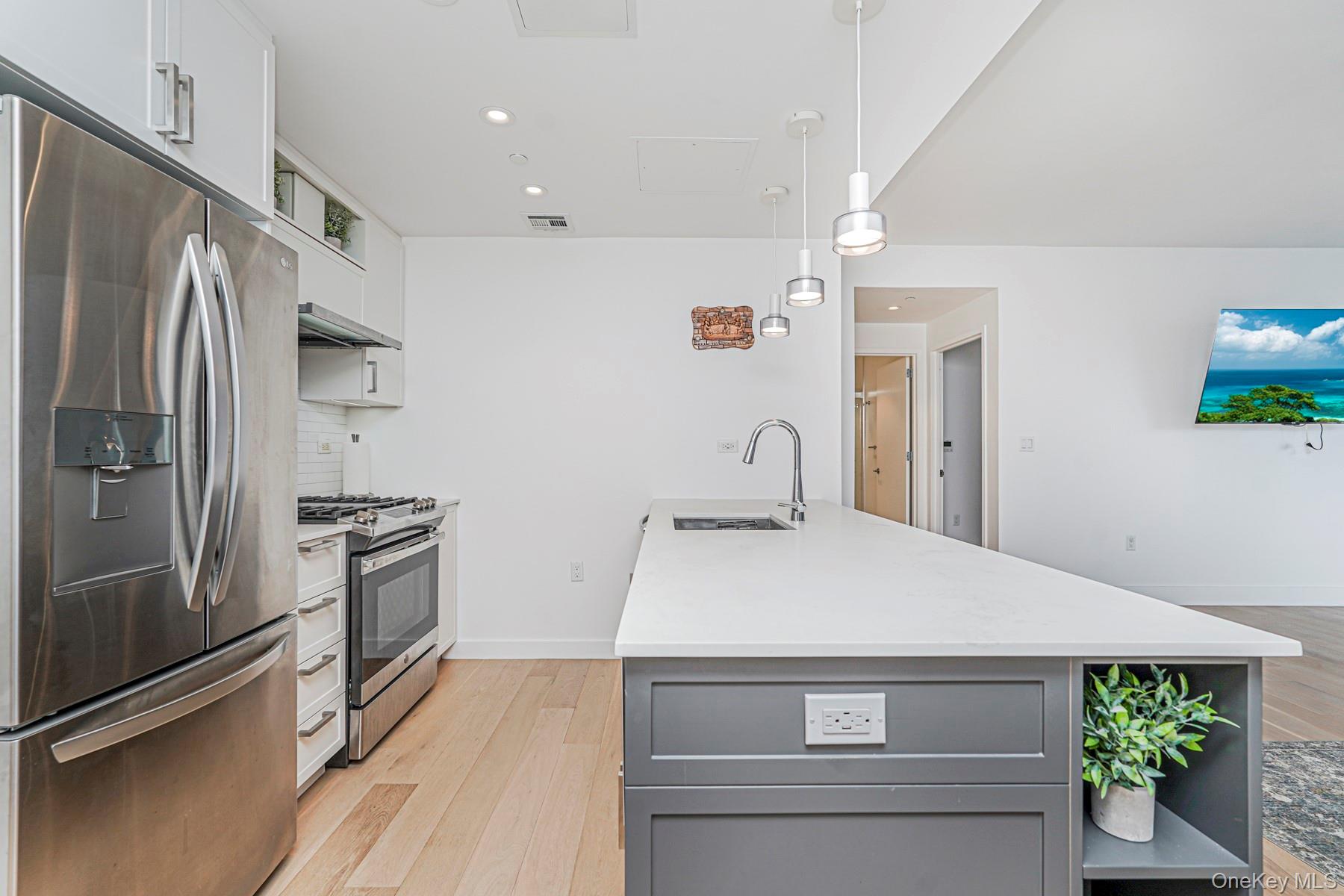 133 Beach 116th Street, Unit 2C Queens, NY 11694 - Photo 8 of 35 a kitchen with a refrigerator and a sink