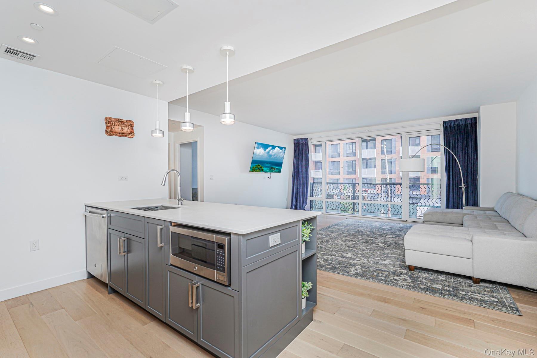 133 Beach 116th Street, Unit 2C Queens, NY 11694 - Photo 35 of 35 a kitchen with a stove and a large window