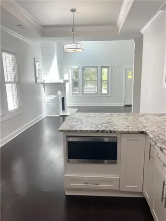 a view of kitchen with granite countertop a sink and a stove