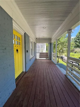 a view of outdoor space with wooden floor and windows
