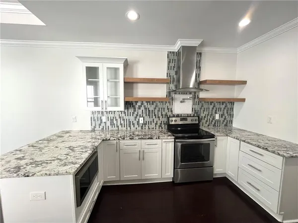a kitchen with stainless steel appliances granite countertop a sink stove and refrigerator