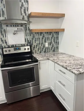a stove top oven sitting inside of a kitchen