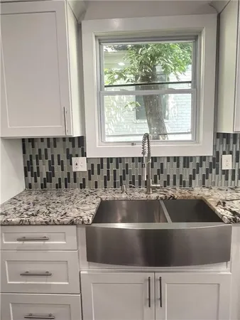 a kitchen with granite countertop a sink and a window