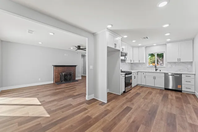 a kitchen with a refrigerator and a stove top oven