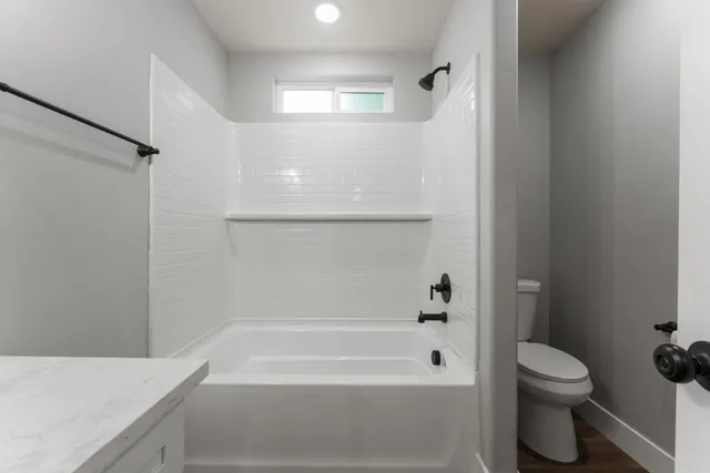 a bathroom with a bathtub and a toilet