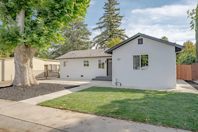 a view of a house with a yard and garage