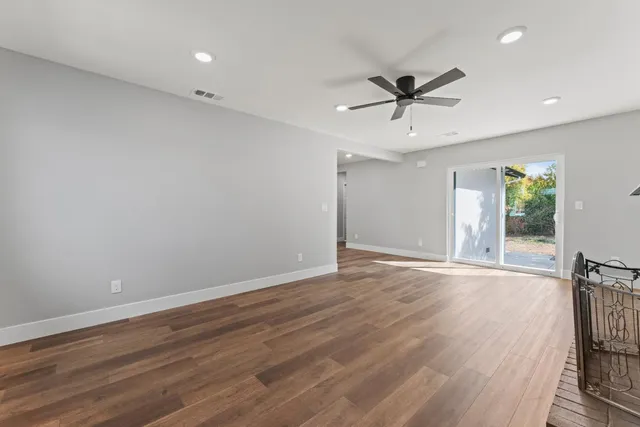 wooden floor in an empty room with a window