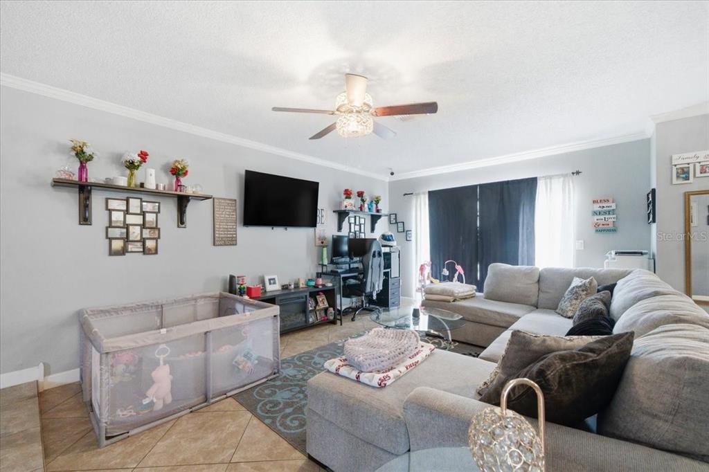 4464 Bromley Avenue Spring Hill, FL 34609 - Photo 11 of 43 a living room with furniture and a flat screen tv