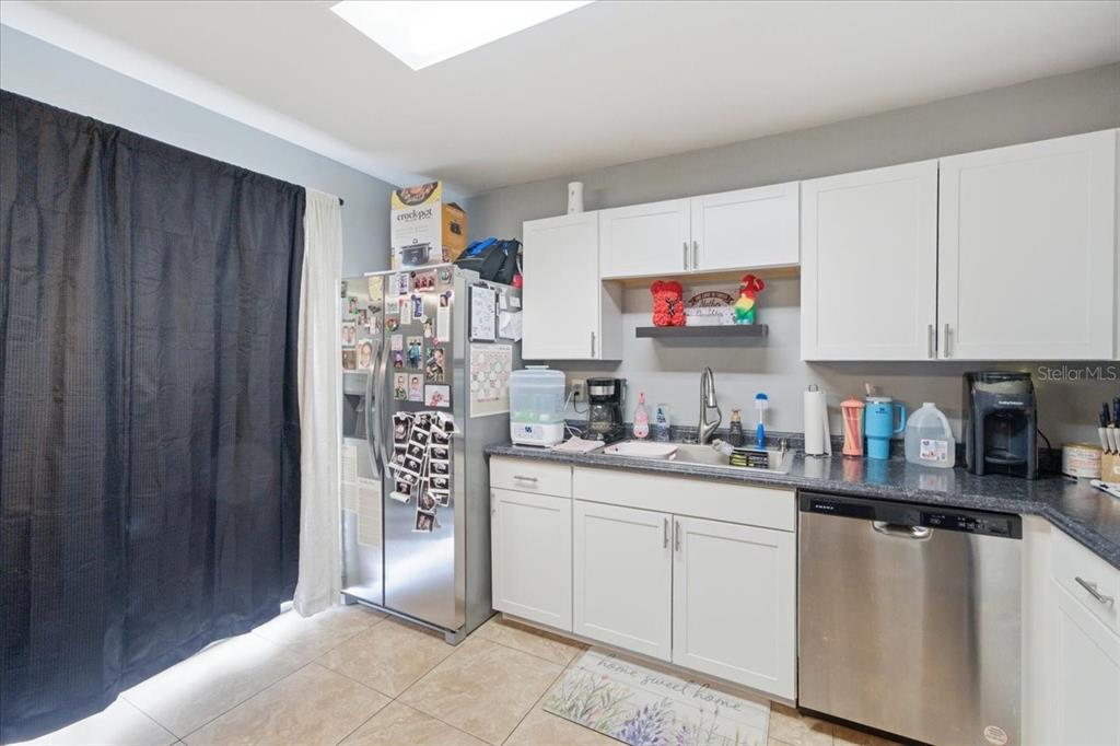 4464 Bromley Avenue Spring Hill, FL 34609 - Photo 17 of 43 a kitchen with cabinets and window