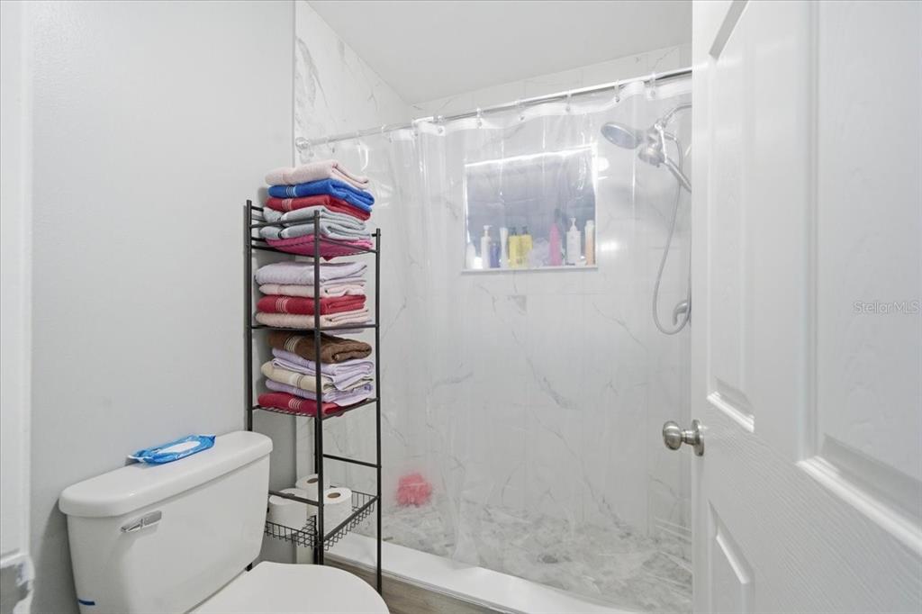 4464 Bromley Avenue Spring Hill, FL 34609 - Photo 30 of 43 a bathroom with a toilet and a shower