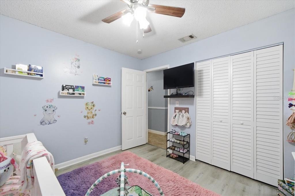 4464 Bromley Avenue Spring Hill, FL 34609 - Photo 33 of 43 a living room with furniture and a flat screen tv
