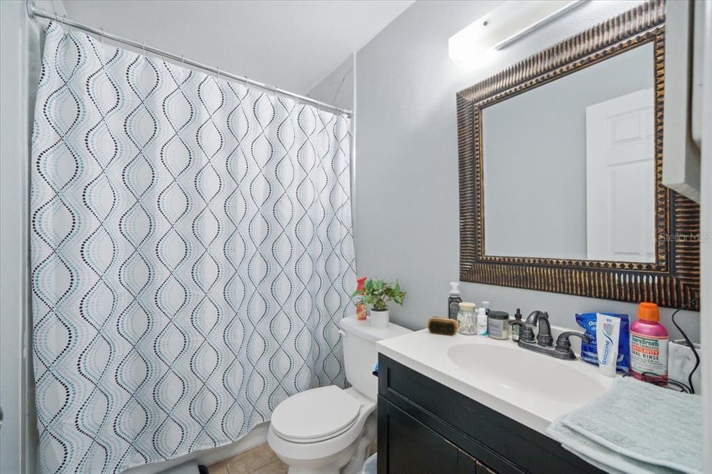 4464 Bromley Avenue Spring Hill, FL 34609 - Photo 34 of 43 a bathroom with a sink a toilet and a mirror