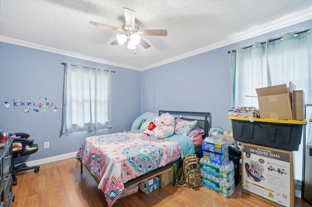 4464 Bromley Avenue Spring Hill, FL 34609 - Photo 35 of 43 a bedroom with a bed and furniture