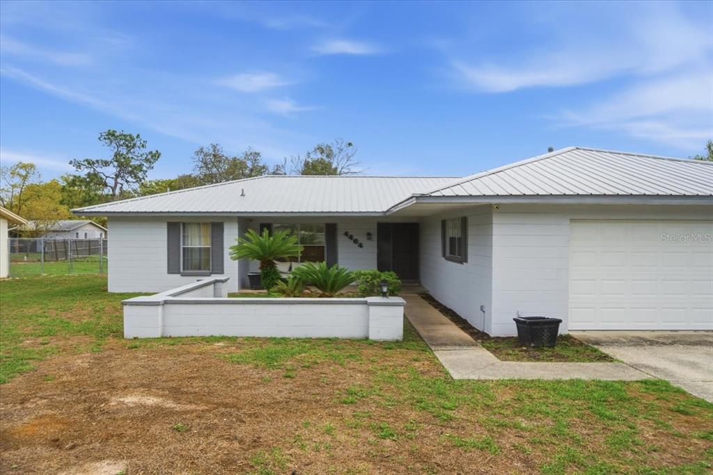 4464 Bromley Avenue Spring Hill, FL 34609 - Photo 4 of 43 a front view of a house with a yard