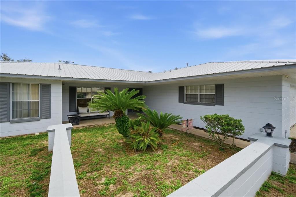 4464 Bromley Avenue Spring Hill, FL 34609 - Photo 7 of 43 a house view with a garden space