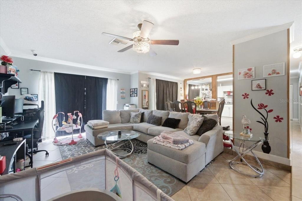 4464 Bromley Avenue Spring Hill, FL 34609 - Photo 10 of 43 a living room with furniture and a flat screen tv