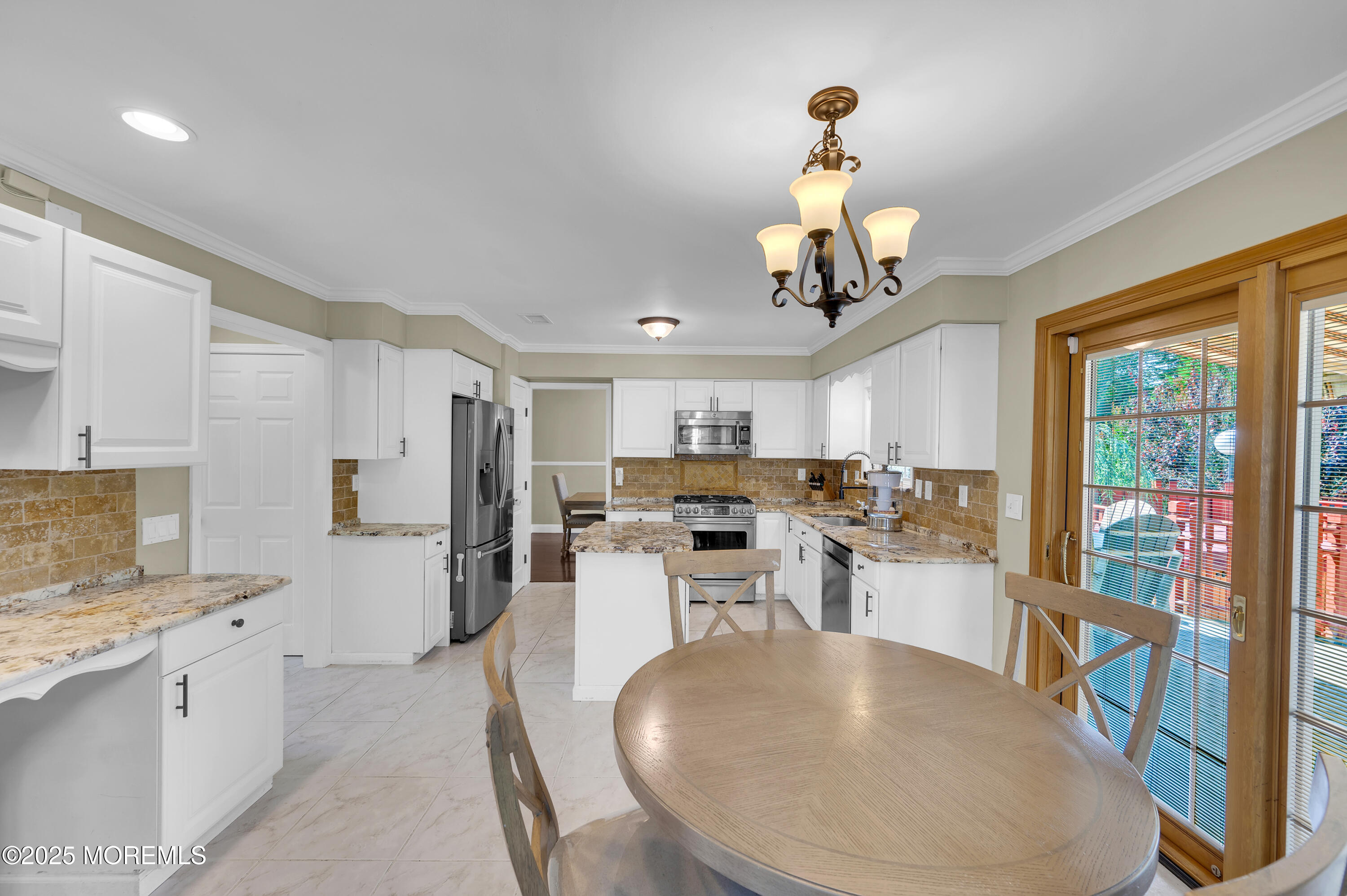 4 Diamond Lane Howell, NJ 07731 - Photo 20 of 63 a view of a kitchen with kitchen island stainless steel appliances wooden floor dining table and a chandelier