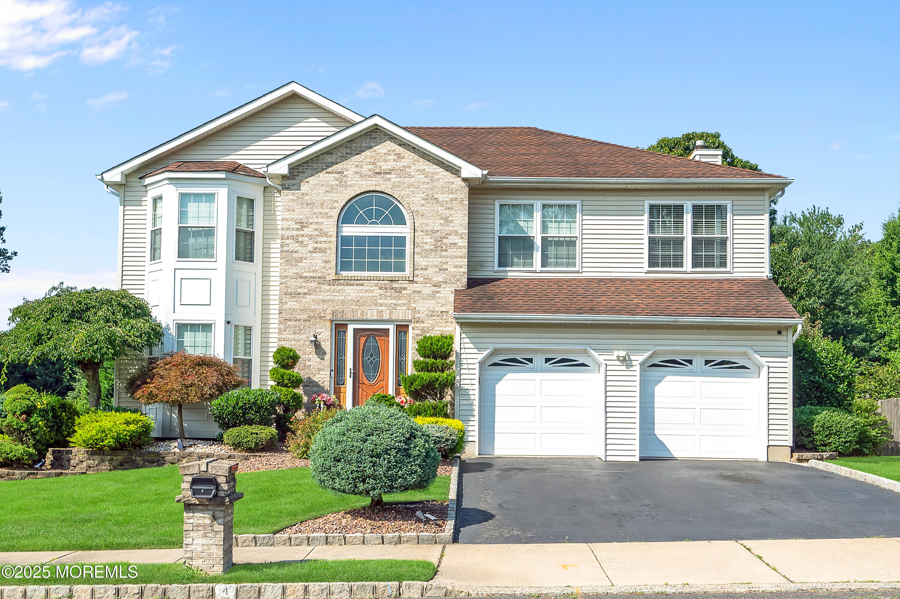 4 Diamond Lane Howell, NJ 07731 - Photo 2 of 63 a front view of a house with a yard and garage