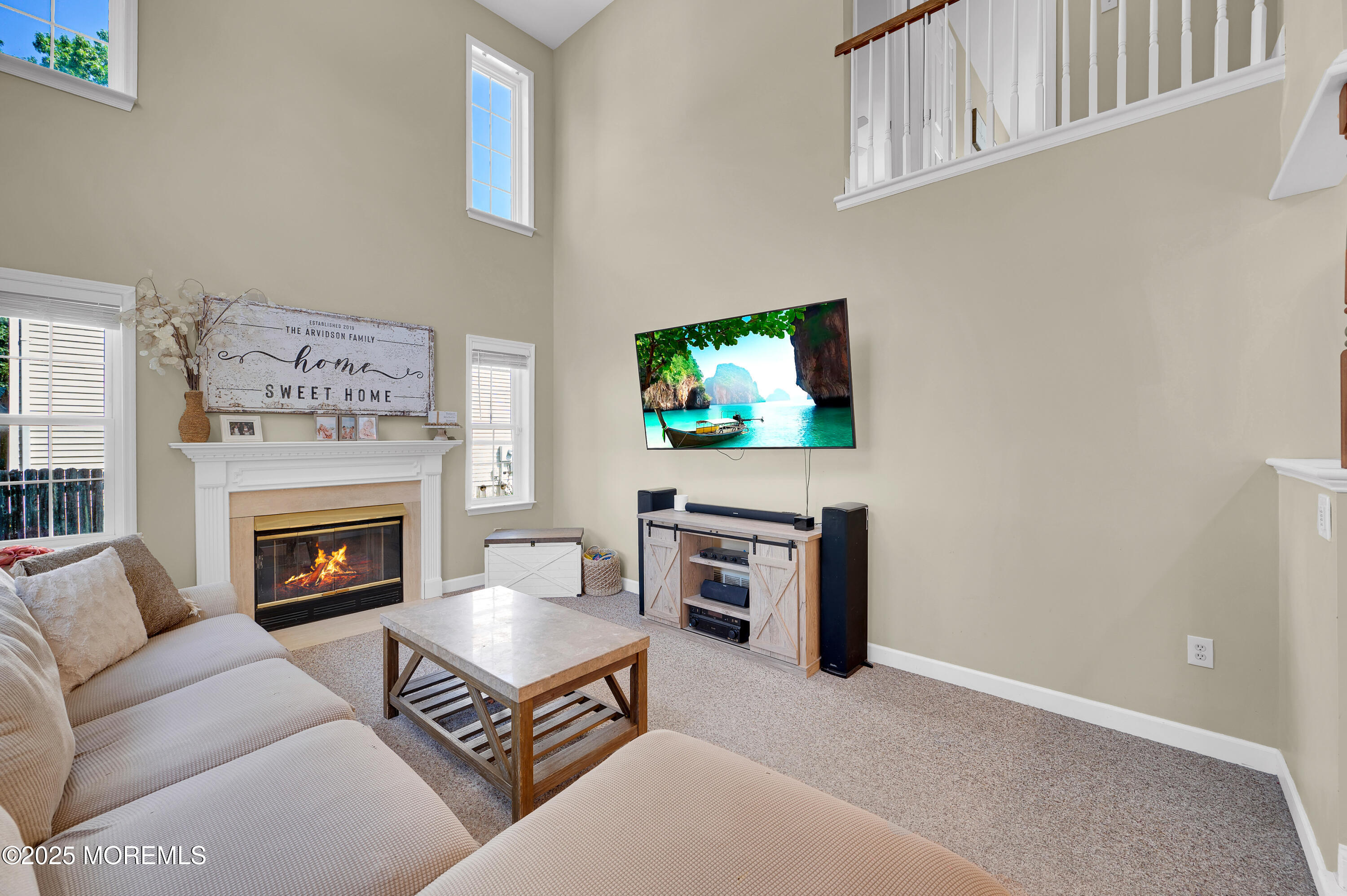 4 Diamond Lane Howell, NJ 07731 - Photo 25 of 63 a living room with furniture a flat screen tv and a fireplace