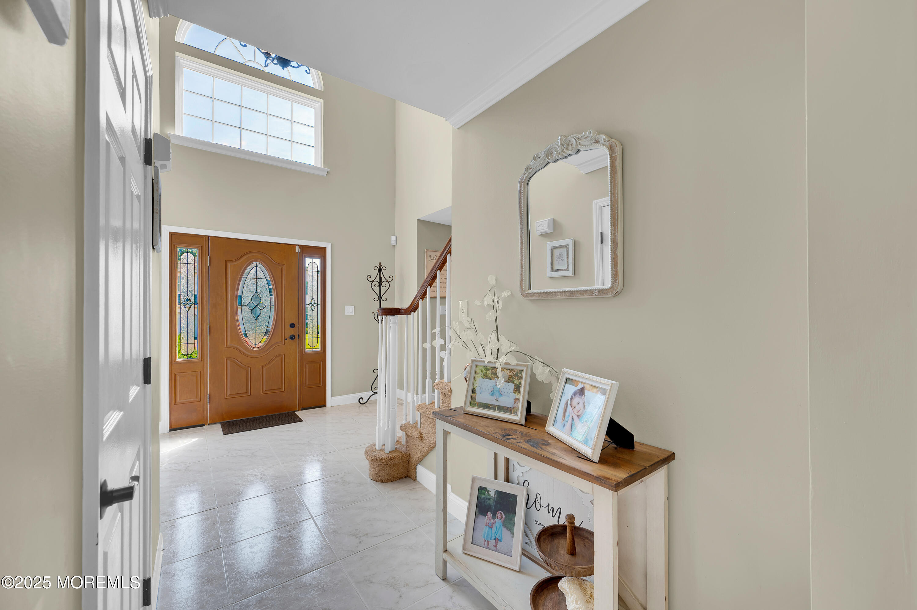 4 Diamond Lane Howell, NJ 07731 - Photo 5 of 63 a view of a hallway with paintings on the wall