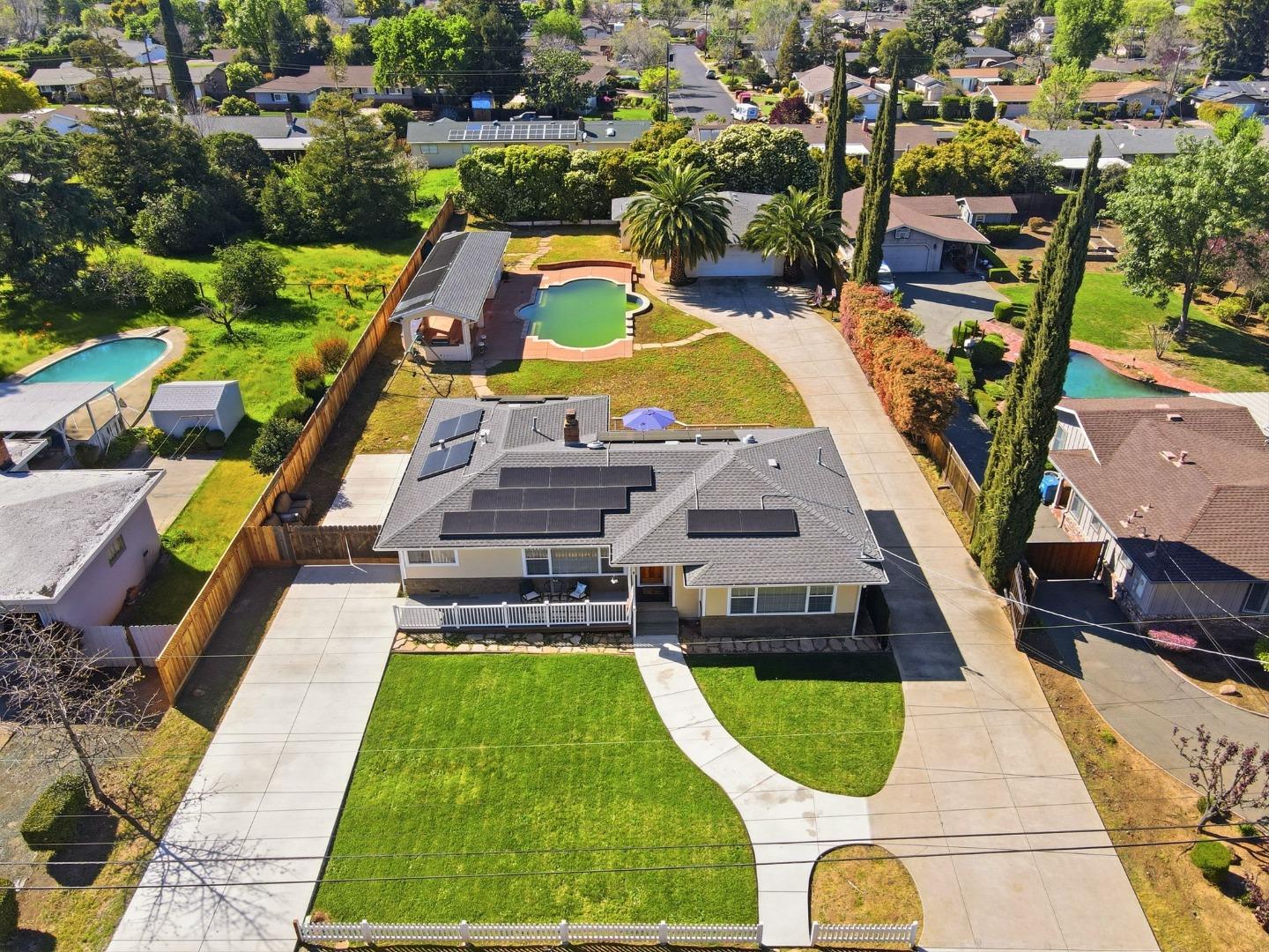 1421 Lydia Lane Clayton, CA 94517 - Photo 1 of 1 an aerial view of a house with swimming pool and large trees