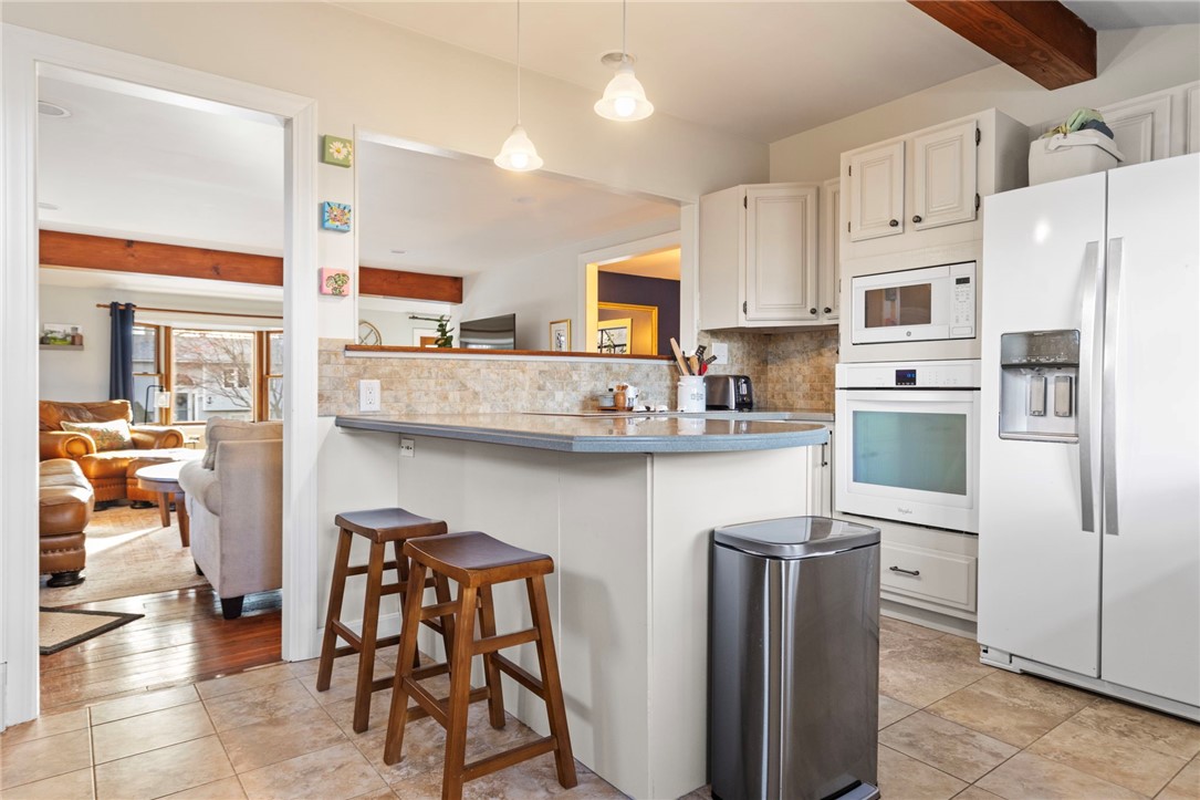 151 Ives Road Warwick, RI 02818 - Photo 15 of 50 The kitchen features a breakfast bar and ceramic flooring.
