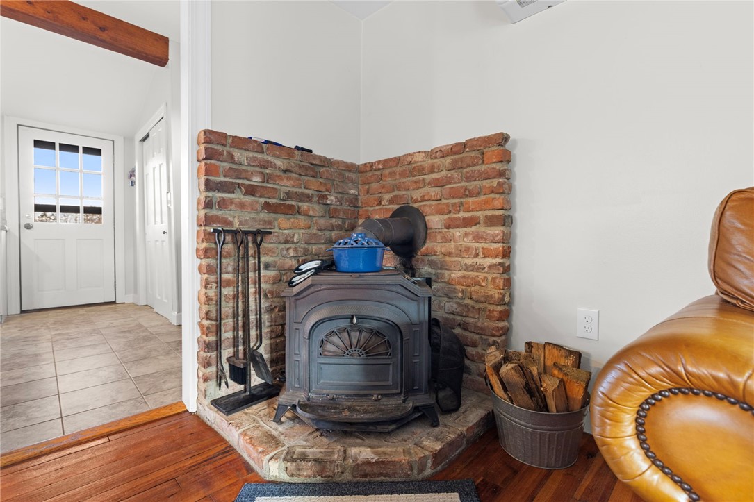151 Ives Road Warwick, RI 02818 - Photo 10 of 50 The living room features a nice wood stove.