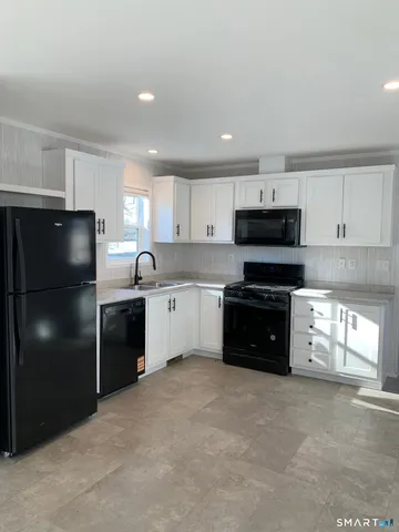 a kitchen with a refrigerator and a sink