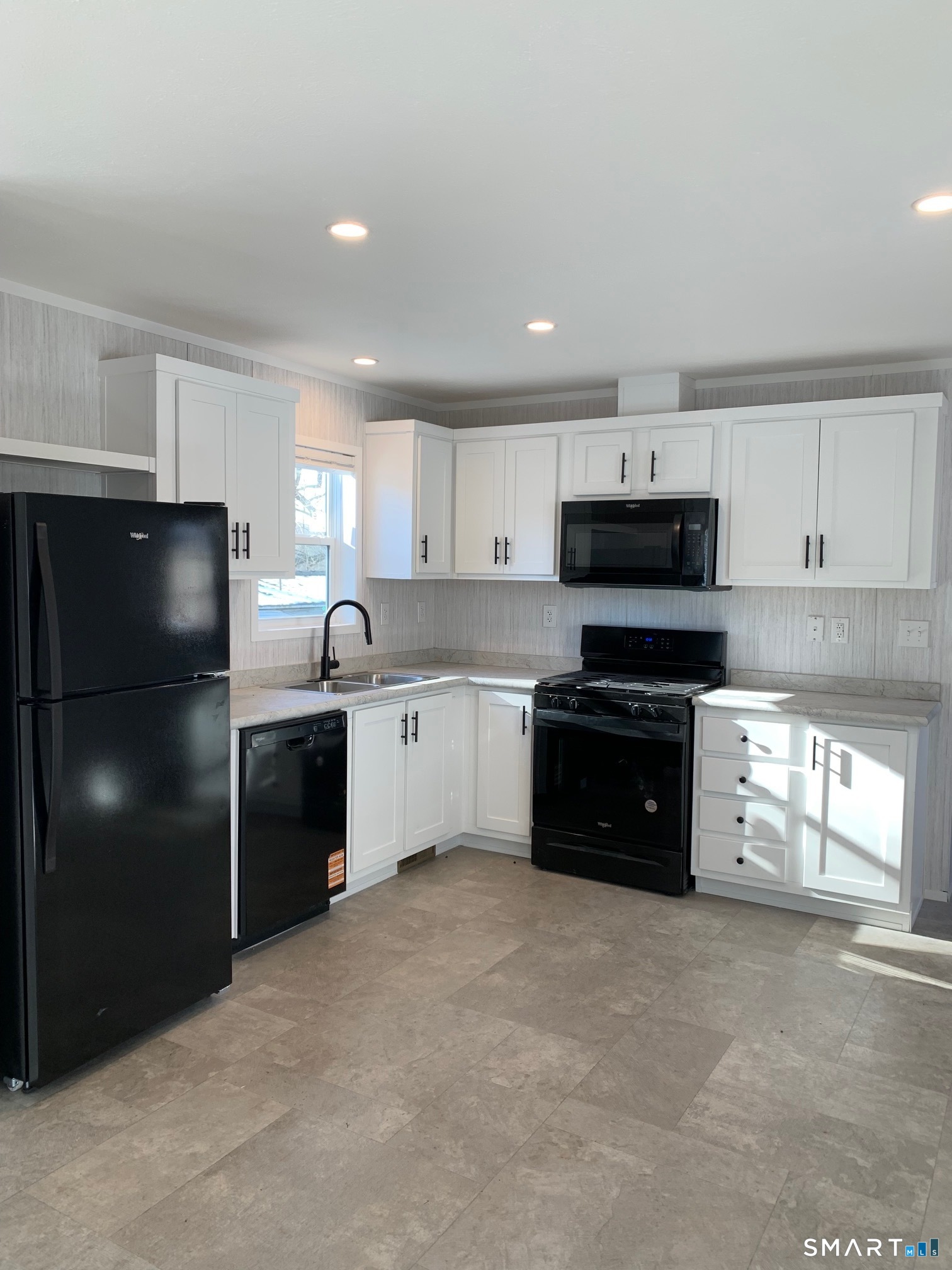 1950 North Broad Street, Unit 27 Meriden, CT 06450 - Photo 2 of 10 a kitchen with a refrigerator and a sink
