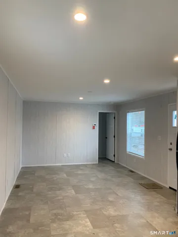 a view of an empty room and a window