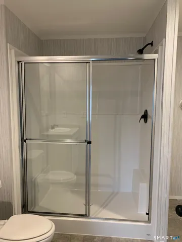 a bathroom with a shower and a toilet