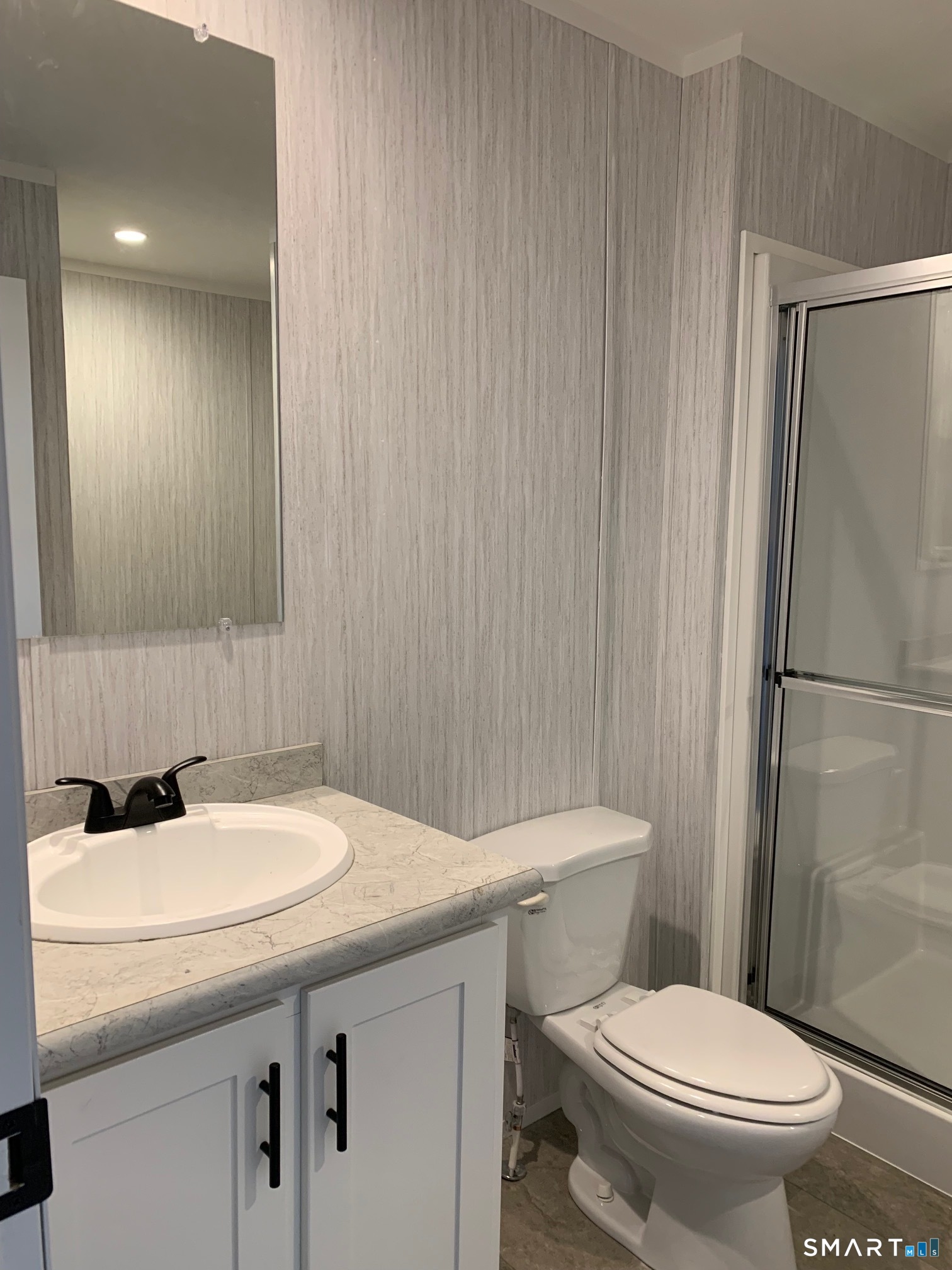 1950 North Broad Street, Unit 27 Meriden, CT 06450 - Photo 10 of 10 a bathroom with a sink a toilet and shower