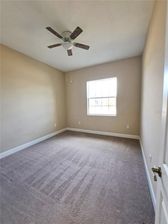 6 Parkview Circle Palm Coast, FL 32137 - Photo 11 of 32 an empty room with a window and a ceiling fan