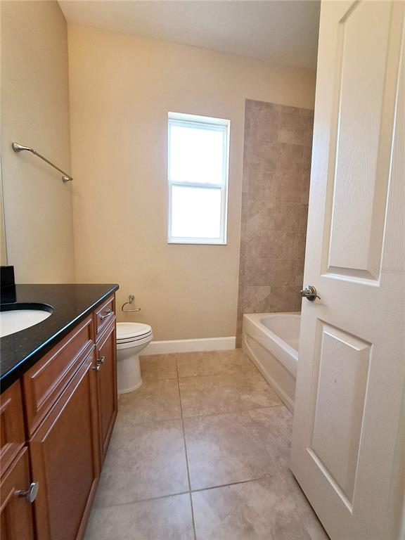 6 Parkview Circle Palm Coast, FL 32137 - Photo 13 of 32 a bathroom with a sink a toilet and tub