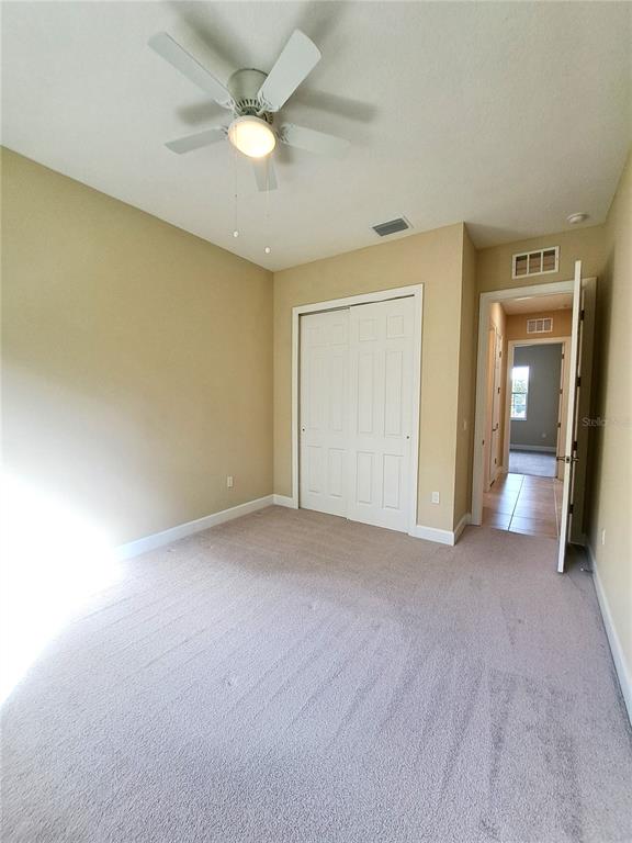 6 Parkview Circle Palm Coast, FL 32137 - Photo 18 of 32 an empty room with closet and a ceiling fan