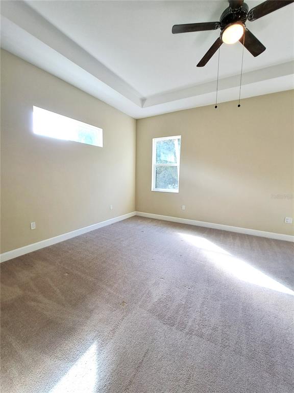 6 Parkview Circle Palm Coast, FL 32137 - Photo 20 of 32 en empty room with windows and fan