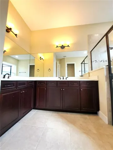 a bathroom with a sink vanity and mirror