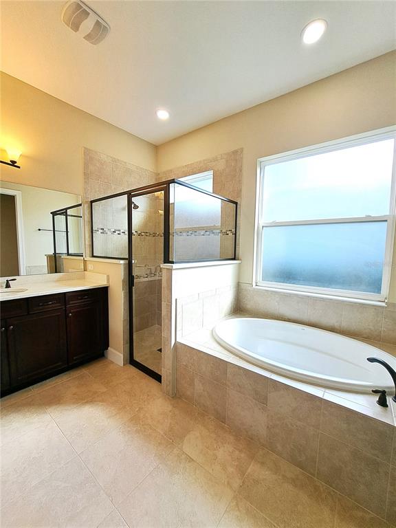 6 Parkview Circle Palm Coast, FL 32137 - Photo 25 of 32 a bathroom with a tub a sink and a large mirror