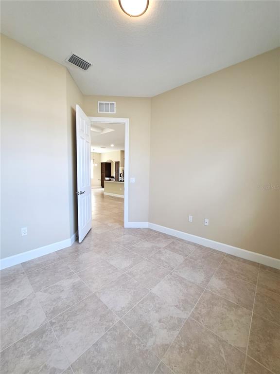 6 Parkview Circle Palm Coast, FL 32137 - Photo 9 of 32 an empty room with a fireplace and a window