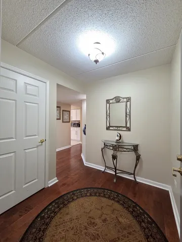 a view of a room with wooden floor and lounge chair