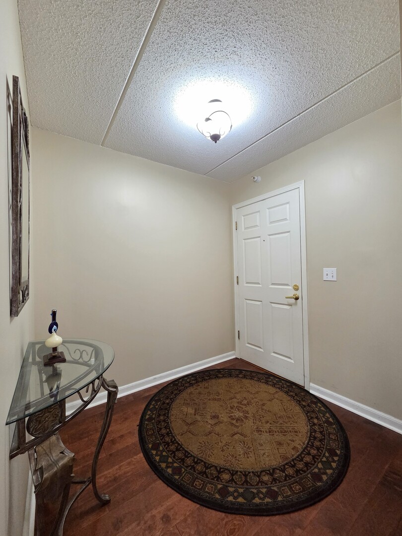 6815 North Milwaukee Avenue, Unit 210 Niles, IL 60714 - Photo 12 of 47 a room with a chandelier