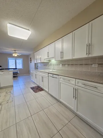 a kitchen with stainless steel appliances granite countertop a sink and cabinets