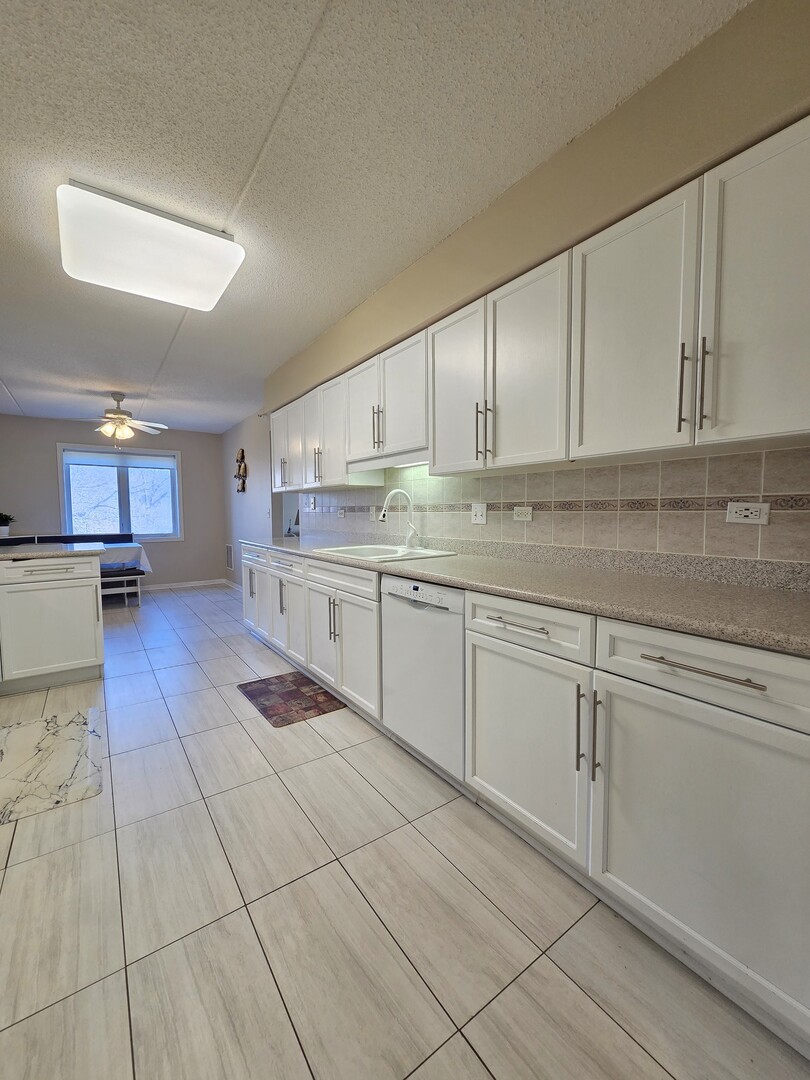 6815 North Milwaukee Avenue, Unit 210 Niles, IL 60714 - Photo 14 of 47 a kitchen with stainless steel appliances granite countertop a sink and cabinets
