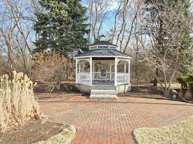 a front view of a house with a tree