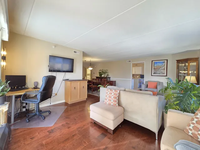 a living room with furniture a flat screen tv and a window