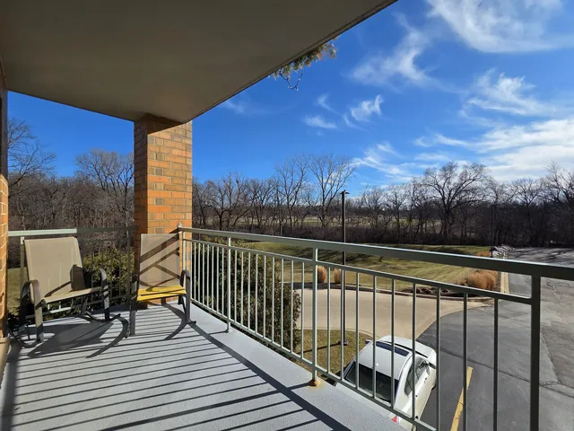 a view of balcony with wooden floor and trees