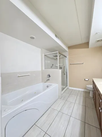 a spacious bathroom with a bathtub and a shower