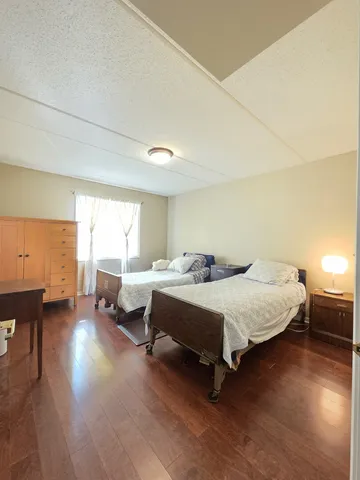 a spacious bedroom with a bed and window