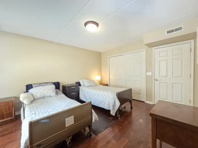 a bedroom with furniture and a wooden floor